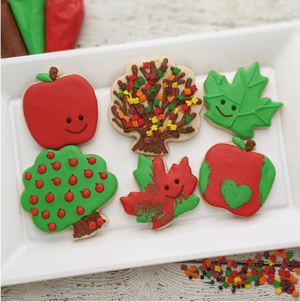 Sugar cookies for decorating featuring a fall themed cookie kit with apple trees and leaves.